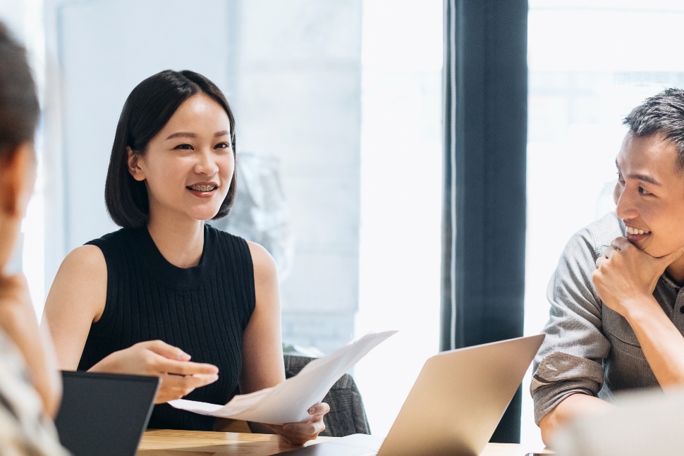 Office workers in discussion in an office environment