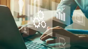 Person typing on laptop with virtual technology icons like gears and graphs.