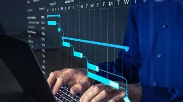 Person typing on a laptop with a Gantt chart overlay on the screen.