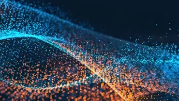 Colorful abstract image showing waves of blue and orange particles on a dark background.