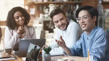 Group of professionals having a meeting in a cozy cafe.
