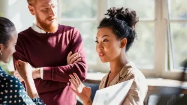 A group of diverse professionals in a discussion on contracting interview questions.