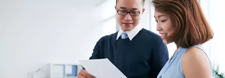 An employer showing his employee a well-written reference letter.