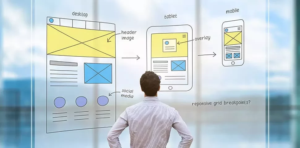 Man viewing website design sketches on transparent board.