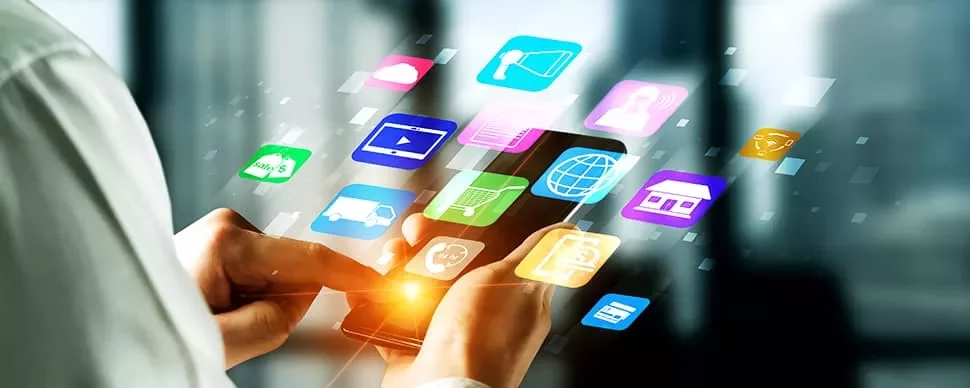 Person holding a smartphone with glowing app icons floating around.