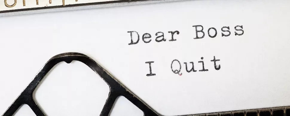 Close-up of a typed resignation note saying, 'Dear Boss, I Quit.'