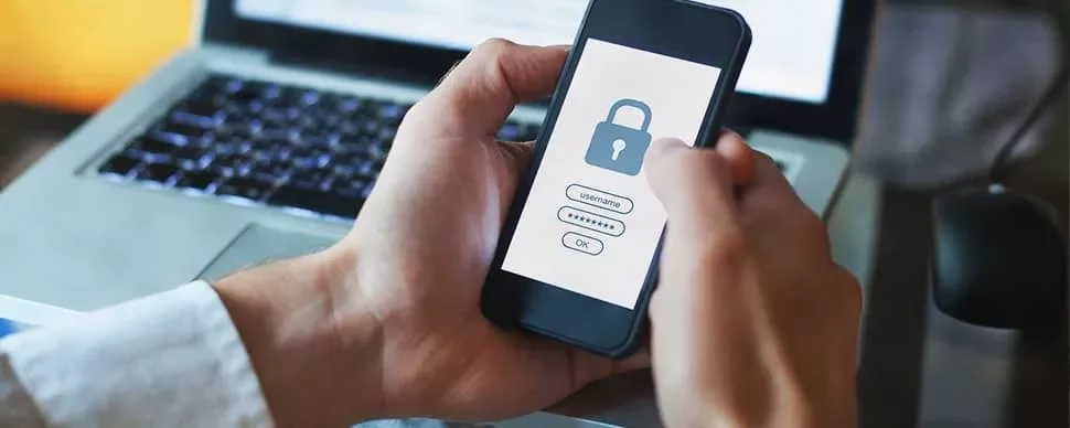Person holding a smartphone displaying a security lock screen.