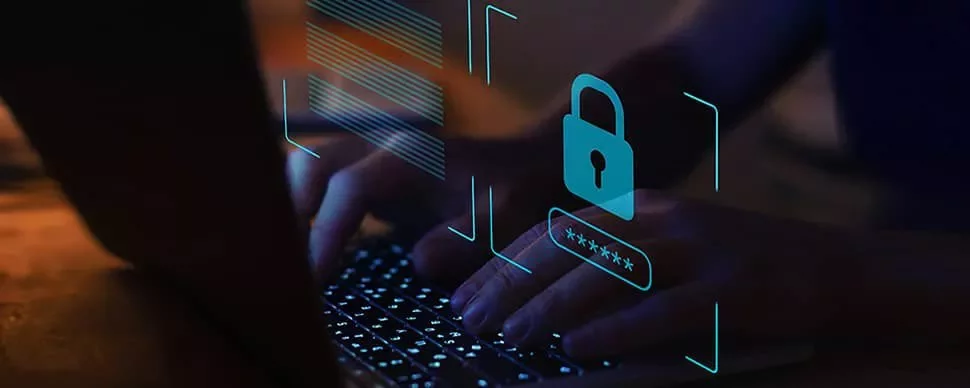 Person typing on a laptop with digital security overlay.