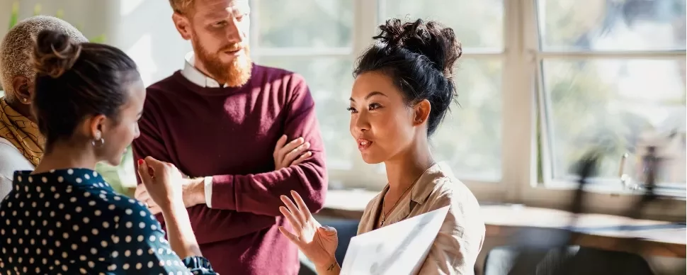 A group of diverse professionals in a discussion on contracting interview questions.