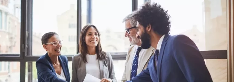 A handshake between business colleagues in an office, illustrating a moment of agreement and professional connection.